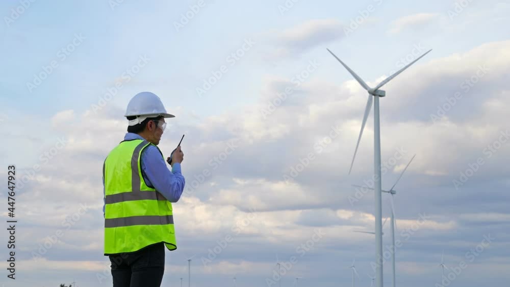 custom made wallpaper toronto digitalYoung male engineer using walkie-talkie to checking system against wind turbine farm.