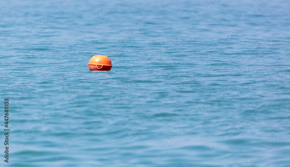 Big orange float on the sea