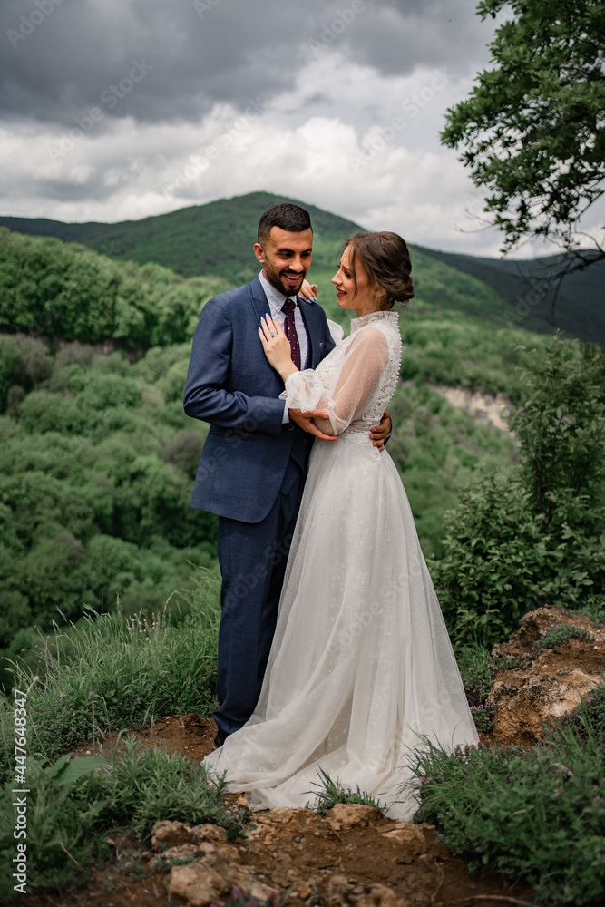 a gentle hugging newlyweds in a wedding ceremony in the mountains