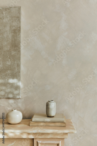 Stylish minimalistic monochromatic composition with design vases and personal accessories. Poster on the wall. Copy space. Neutral colors. Template.