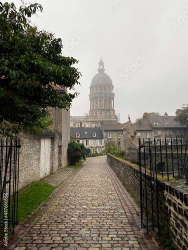 Basilica of Our Lady of the Immaculate Conception at the fortified city of Boulogne-sur-Mer, castle in foreground. Cloudy and rainy day with unrecognizable person