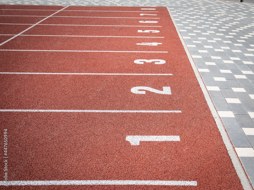 Fototapeta premium Starting position. Red running track in stadium