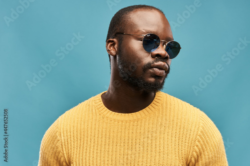 Εκτύπωση καμβά portrait photo of a dark-skinned handsome guy with a beard on a blue background