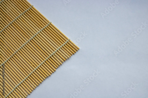 Bamboo napkin for making sushi, isolated on a white background. Space for text