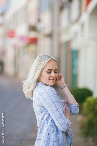 Portrait of a beautiful young woman in a European city. Makes purchases. Tourism. Summer.