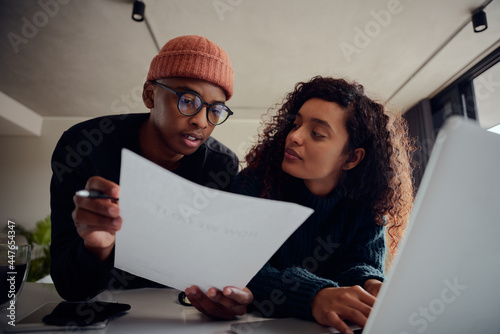 Bilde på lerret Close up of mixed race couple using laptop for online banking