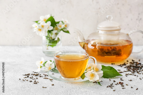 Photography Composition with cup of jasmine tea and flowers on light background