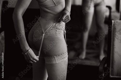 a close - up of the beautiful figure of a girl who is dressed in underwear is visible from behind.Black and white photo photo