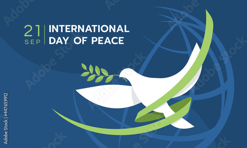 Fotografering International day of peace - The white peace dove flying with green ribbon roll