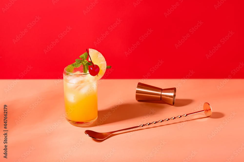Glass of delicious mai tai cocktail on color background Photos | Adobe Stock