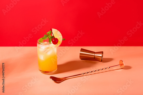 Glass of delicious mai tai cocktail on color background photo
