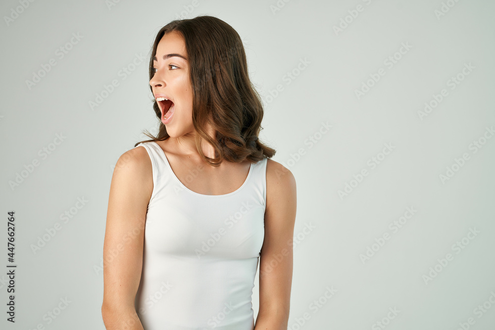 cheerful brunette in a white t-shirt fashionable hairstyle studio lifestyle cheerful brunette in a white t-shirt fashionable hairstyle studio lifestyle