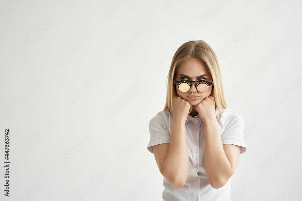 cheerful blonde in a white shirt gold coins in glasses cryptocurrency