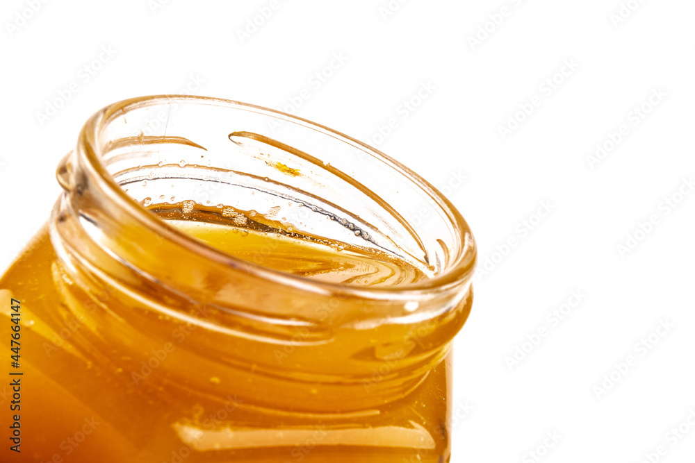 Glass jar full of sweet honey isolated on white background Glass jar full of sweet honey isolated on white background