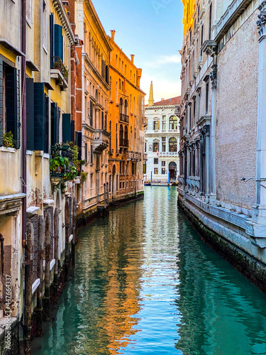 Small canal in Venice  Italy  with balcony  and  blue sky reflexion on water  no boat  no people