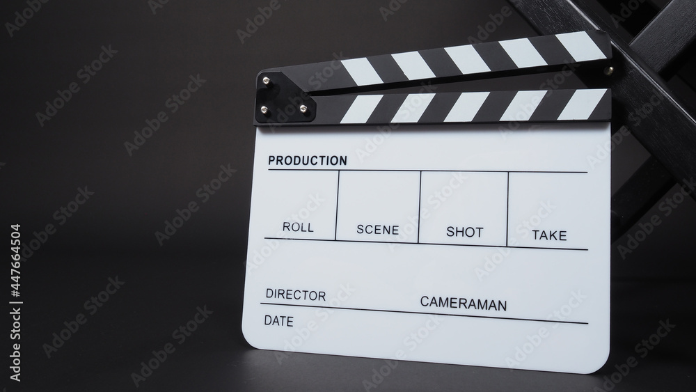 Obraz premium Clapperboard or clap board or movie slate with director chair use in video production ,film, cinema industry on black background.