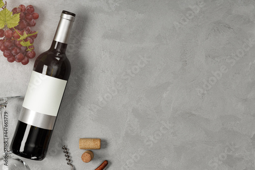 Bottle of red wine with label. Glass of wine and grape. Wine bottle mockup...