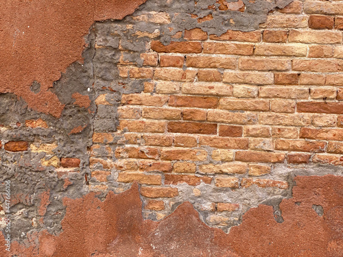 Horizontal part of Old Venetian red brick wall with devastating bricks
