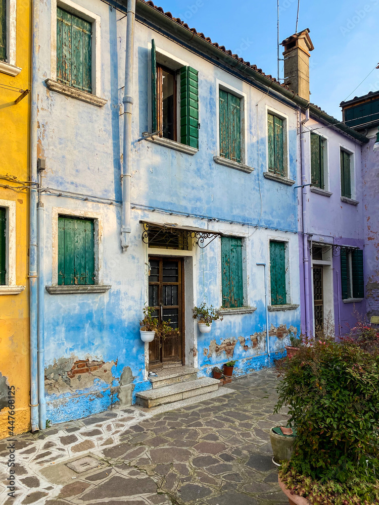 Multicolored houses on a little square at Burano island, Venice, Italy