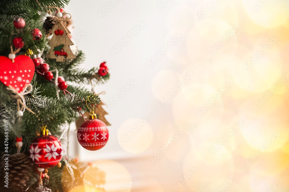 Christmas background with tree and balls, garland in defocus. New year card and copy space.