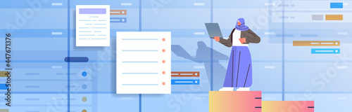 arab businesswoman working on laptop business planning multitasking time management concept