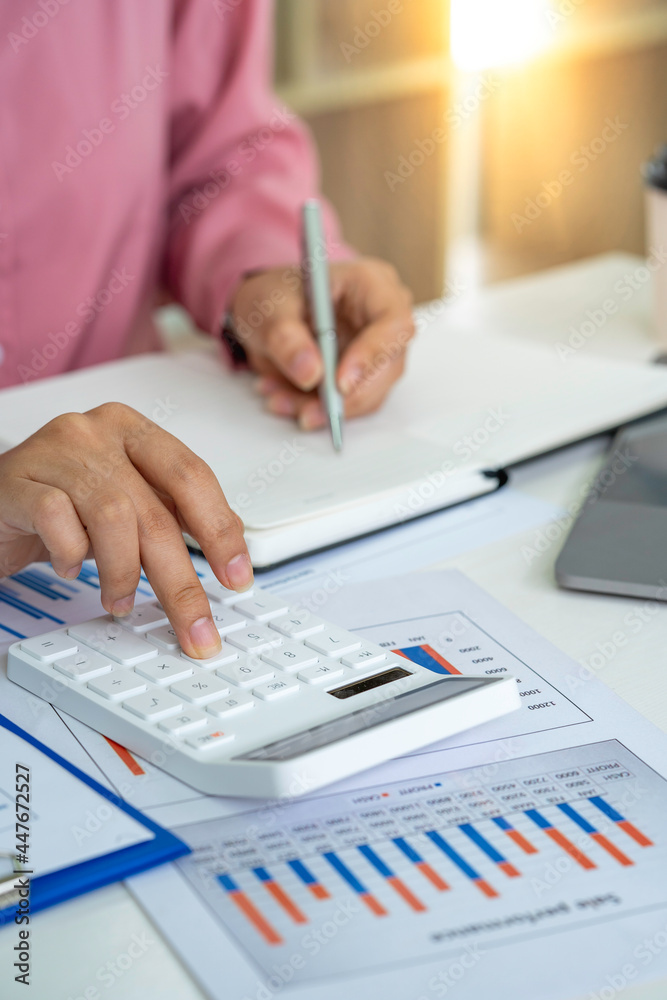 A male accountant or a business man uses a laptop to calculate investment results. And making financial reports on the desk Business finance accounting concept A male accountant or a business man uses a laptop to calculate investment results. And making financial reports on the desk Business finance accounting concept