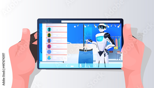 salesman robot showing clothes on smartphone screen in fashion boutique artificial intelligence technology concept