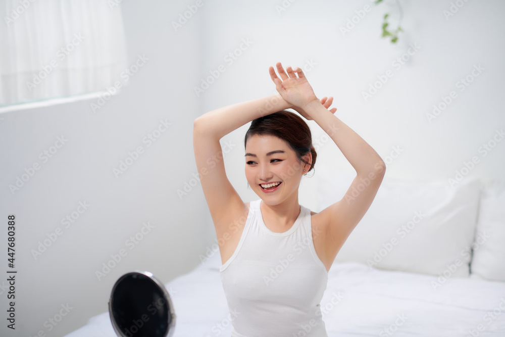 young beautiful woman raises her hands and shows her perfect clean smooth healthy skin of the armpits young beautiful woman raises her hands and shows her perfect clean smooth healthy skin of the armpits