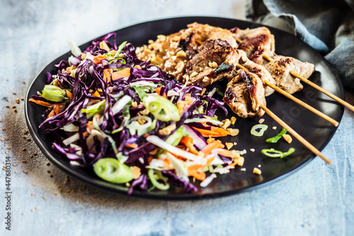 Sate skewers with peanut sauce and red cabbage salad in Thai style photo