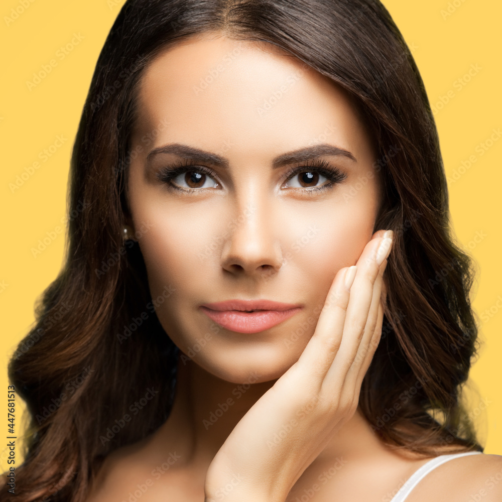 Portrait of beautiful woman in white casual tank top, over yellow color background. Brunette lovely girl at studio fashion concept. Square composition image. Portrait of beautiful woman in white casual tank top, over yellow color background. Brunette lovely girl at studio fashion concept. Square composition image.