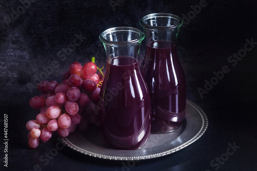 Red grape juice in a glass carafes photo