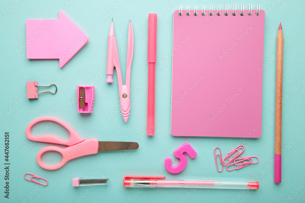 Pink school supplies on blue background. Back to school concept. Pink school supplies on blue background. Back to school concept.