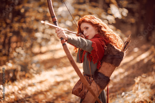 girl archer shooting in woods Fototapeta