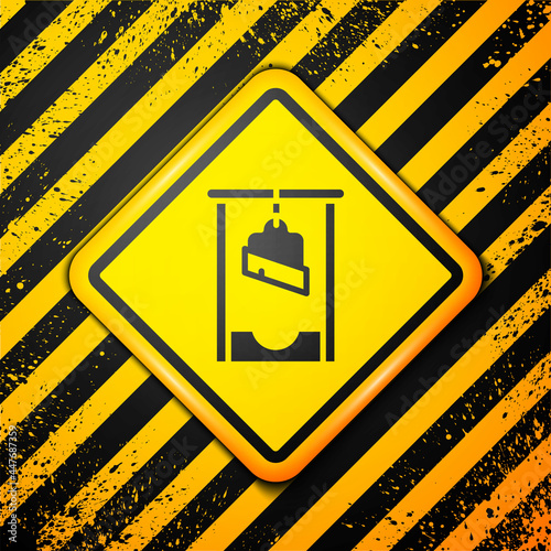Black Guillotine medieval execution icon isolated on yellow background. Warning sign. Vector