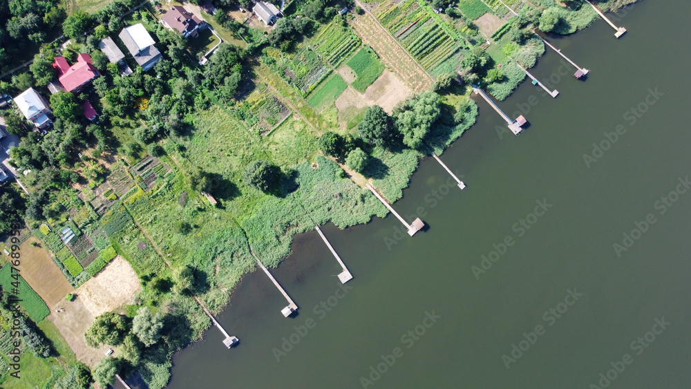 Fototapeta premium Lake pier, aerial view, photography from a drone. Top view of Fishing pier on river .