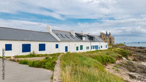 The Turpault castle at Quiberon peninsula, with traditional houses on the coast 