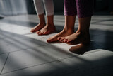 baby feet close-up on the floor, sun rays. yoga class for children