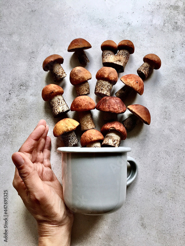 Aspen leaves spilling out of the mug like a fan and a hand.