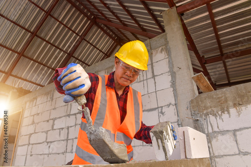 Construction mason worker bricklayer on new home photo