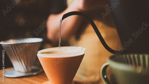 barista brewing a coffee filter drip in the morning, beverage drink with fresh black espresso aroma, hot drink in cup of cafes, brown caffeine in bar shop background