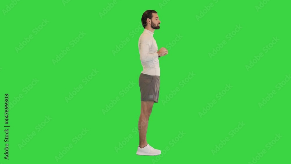 Attractive fit caucasian sportsman doing warm up exercises for neck on a Green Screen, Chroma Key. Attractive fit caucasian sportsman doing warm up exercises for neck on a Green Screen, Chroma Key.