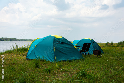 Tourist tents for camping on the lake shore, travel history. fishing, tourism, active recreation. Natural landscape. For lifestyle design. Outdoor recreation