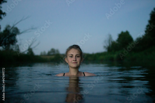 Fototapeta Naklejka Na Ścianę i Meble -  young girl swim evening at the river