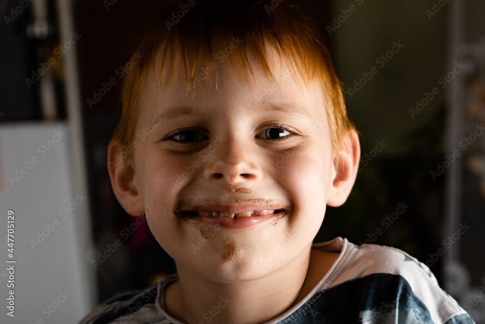 A young boy with a soiled ice cream face. A young boy with a soiled ice cream face.