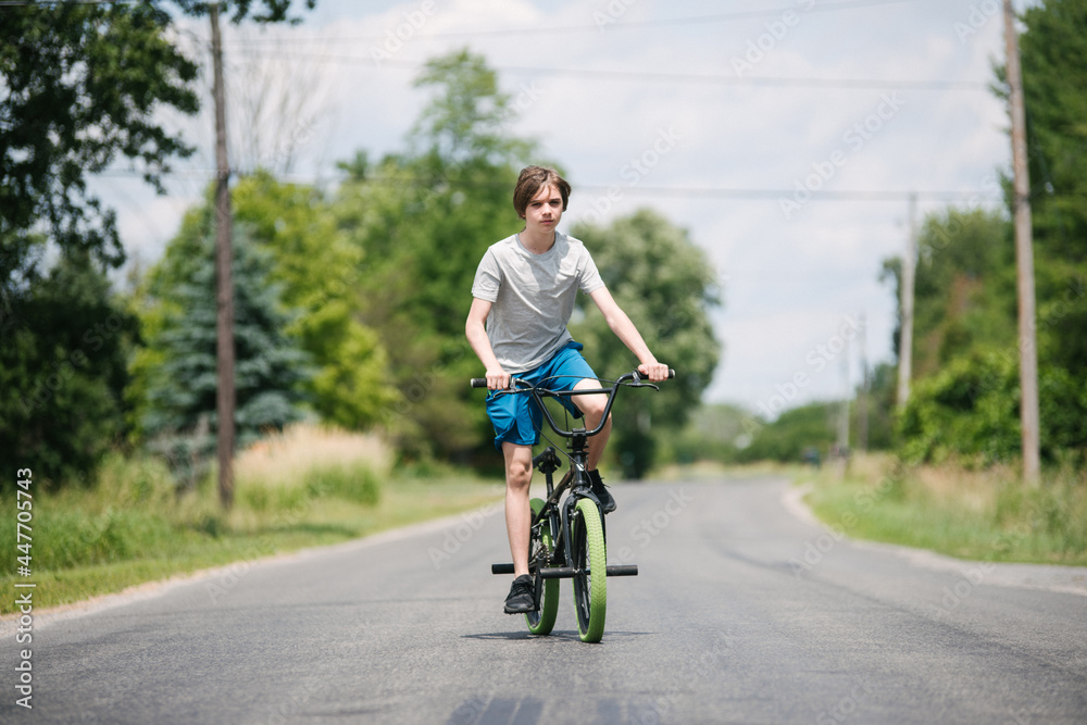 Canada, Ontario, Kingston, Boy (14-15) riding bicycle Canada, Ontario, Kingston, Boy (14-15) riding bicycle