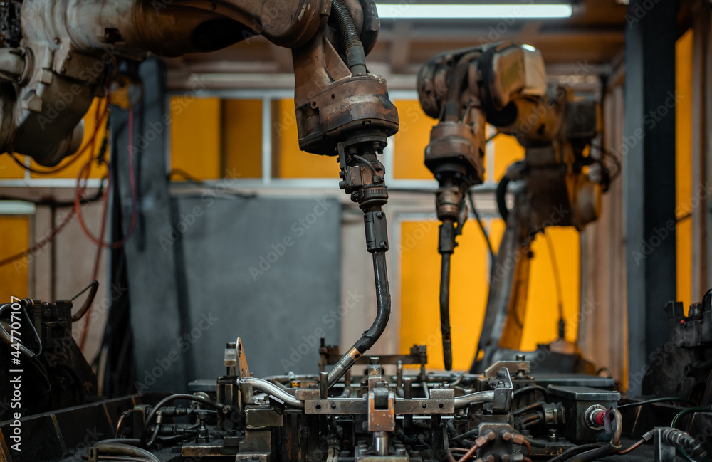 Robot arms machine in intelligent factory industrial on monitoring system software. Welding robotics and digital manufacturing operation. Robot arms machine in intelligent factory industrial on monitoring system software. Welding robotics and digital manufacturing operation.
