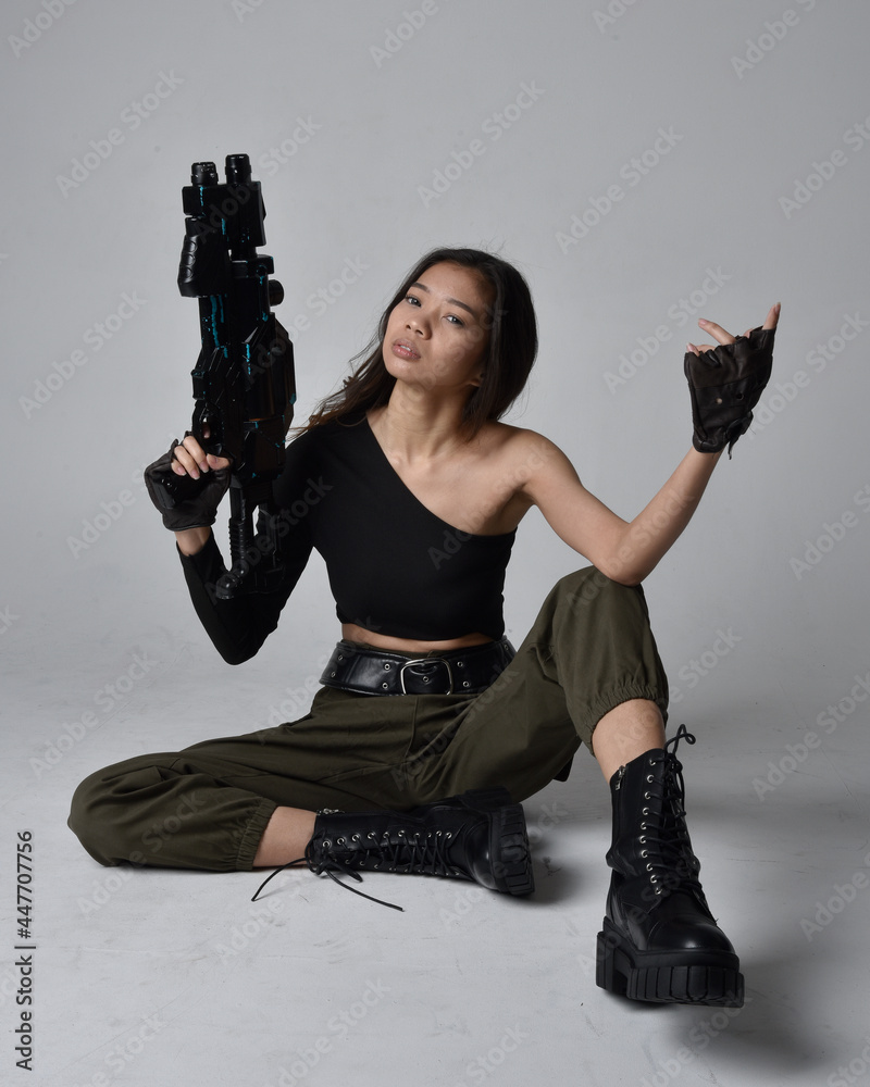 Girl In Action Pose With Gun Isolated On White Background Stock Photo,  Picture and Royalty Free Image. Image 15348569.