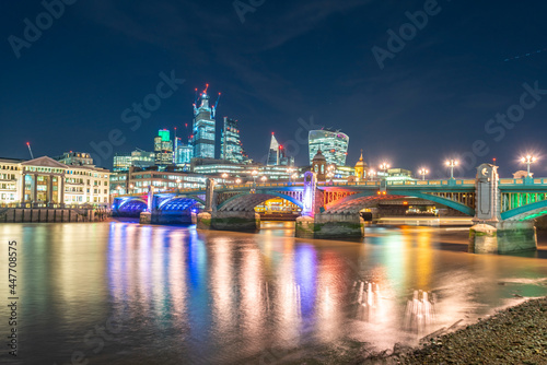 UK, London, Southwark Bridge and City of London at night
