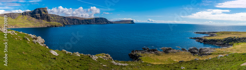 A panorama view from the lighthouse at Neist Point across the bay on the island of Skye, Scotland on a summers day
