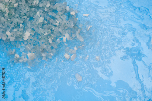Ice melting rock salt crystals on blue ice © Kevin Brine